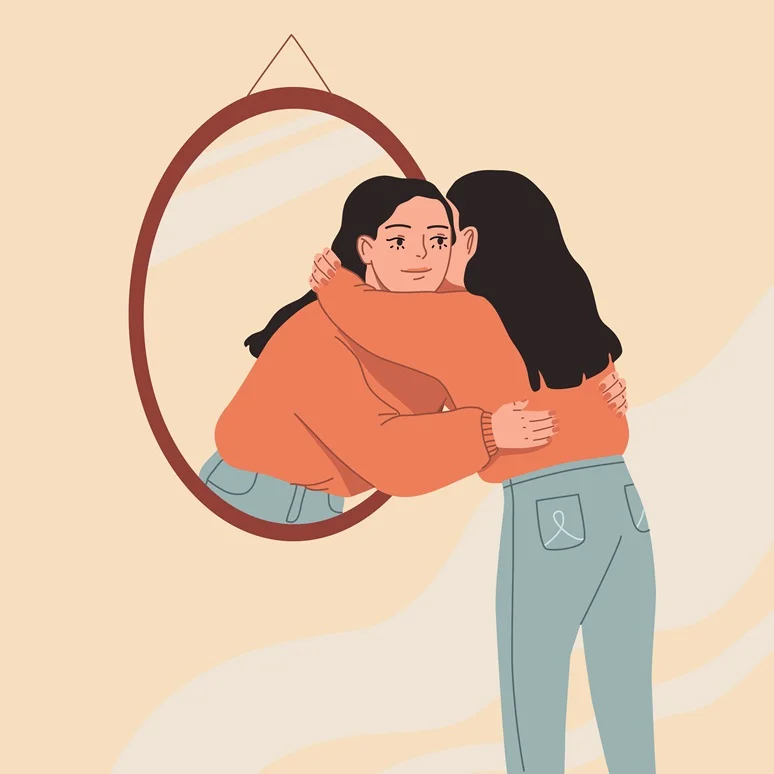 Two women embracing each other in a warm hug, reflected in a hanging oval mirror.