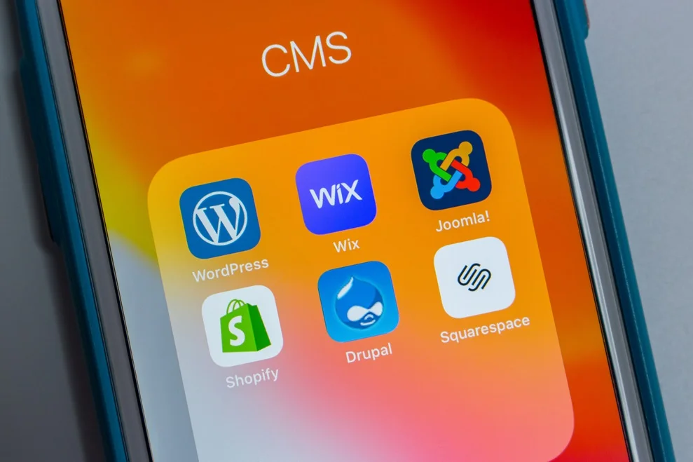 Mobile screen displaying top CMS icons: WordPress, Wix, Joomla, Shopify, Drupal, Squarespace for ecommerce